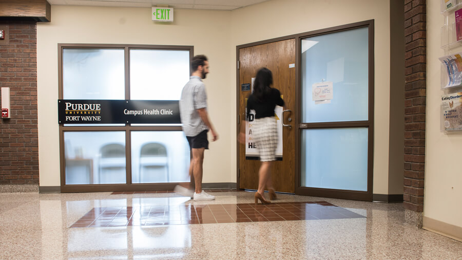 Two students walk into the Health Clinic.