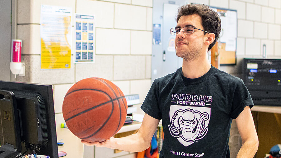 A student holding a basketball