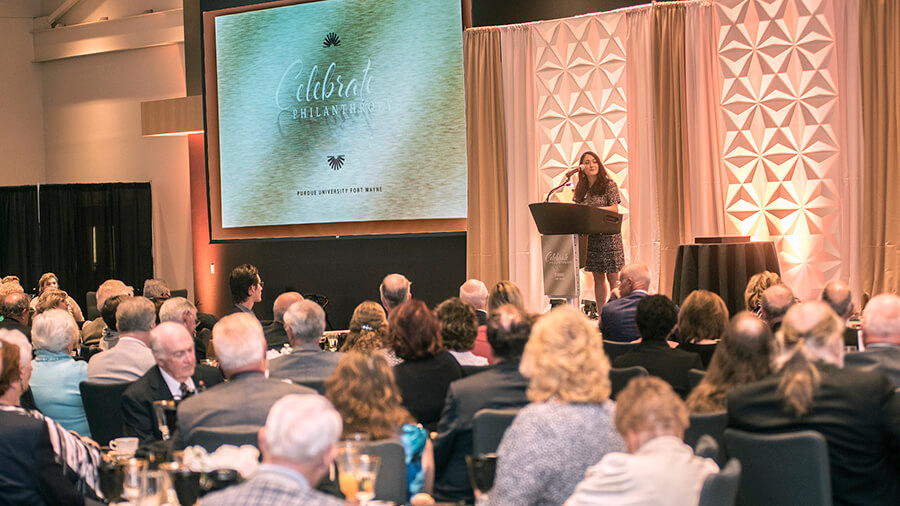 A crowd listens intently to a speaker during a Celebrate Philanthropy event.
