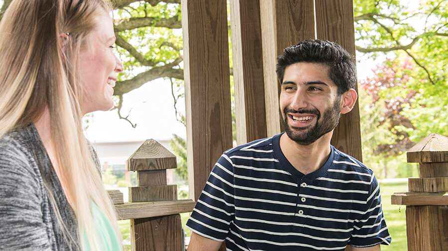 Students sitting under the on campus Gazebo.