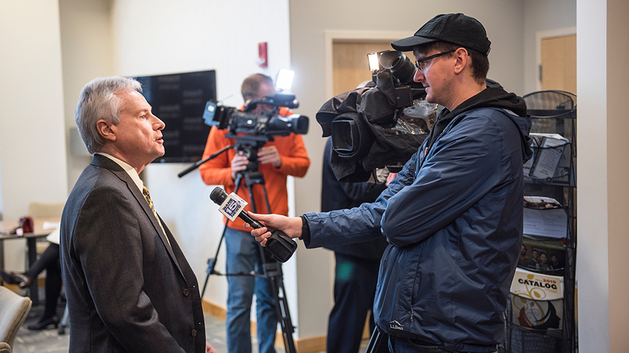 Chancellor Elsenbaumer talks to a reporter from a TV station.
