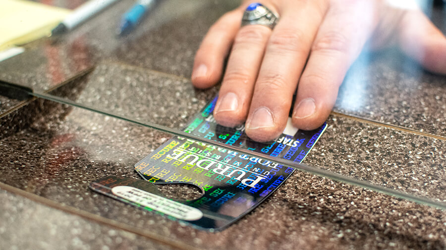 A hand sliding a parking pass across a table.