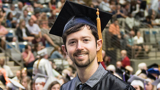 Student in their cap and gown at commencement.