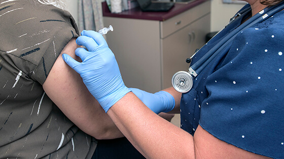 PFW health clinic nurse administers a shot.