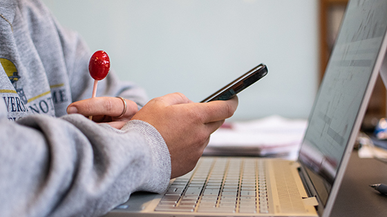 A student checks her phone while working on her FAFSA.