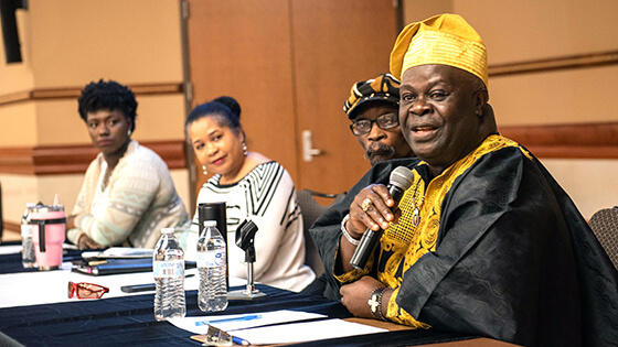 Members of a panel of black speakers take questions during a university event.