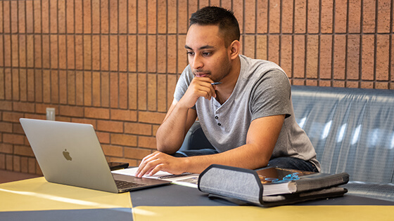 A student signs up for fall 2020 classes on a laptop.