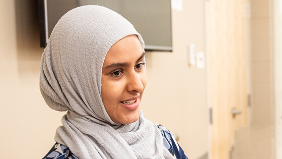 A College of Professional Studies student smiles while in class.