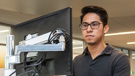A student worker in the Career Development Center works on a computer.