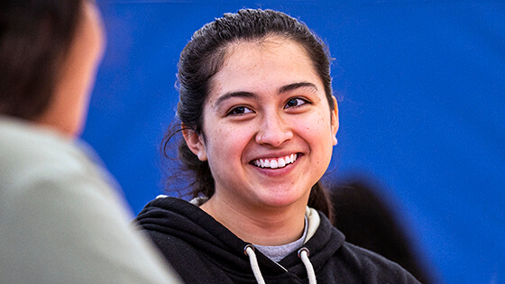 A student smiles during a conversation.