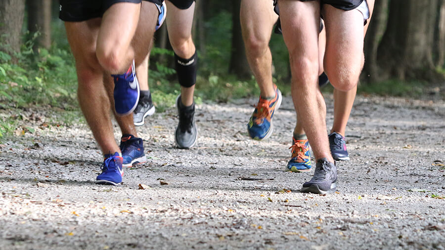 People running on a gravel path