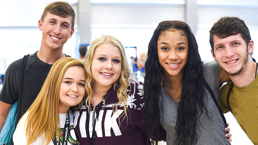 Students posing for a photo in Gates Sports Center
