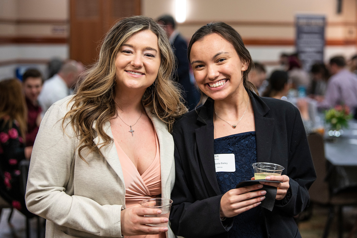 Students smile at commencement