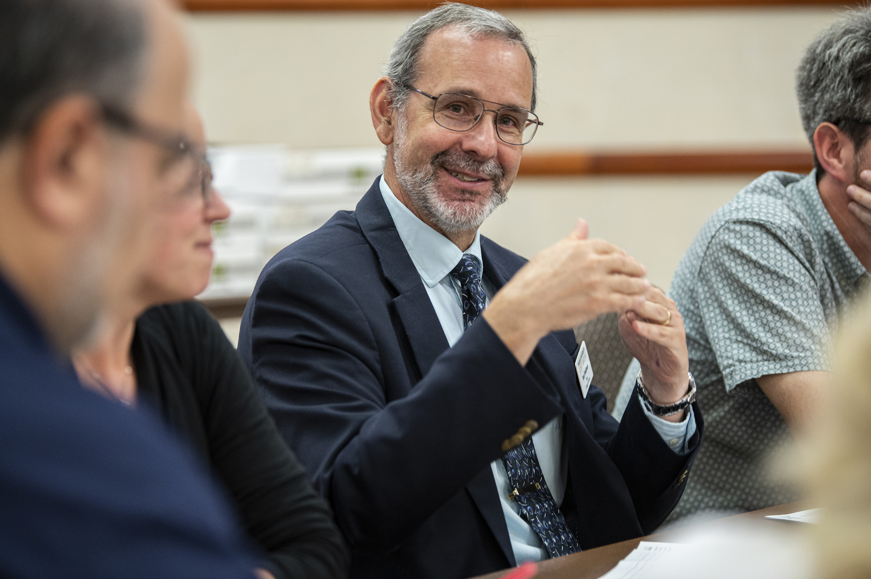 Two instructors listen intently to a lecture.