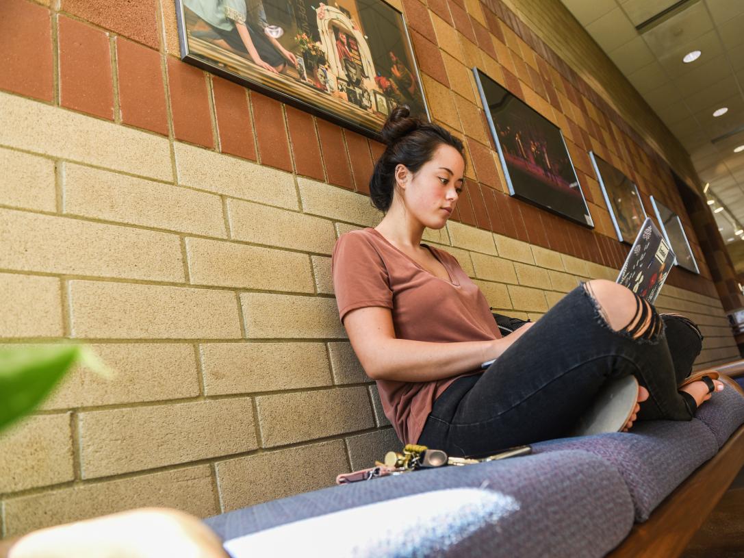 Student studying in a hallway.