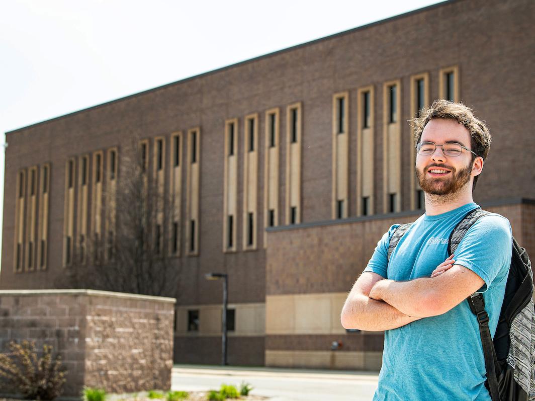 Student poses for a photo outside on campus.