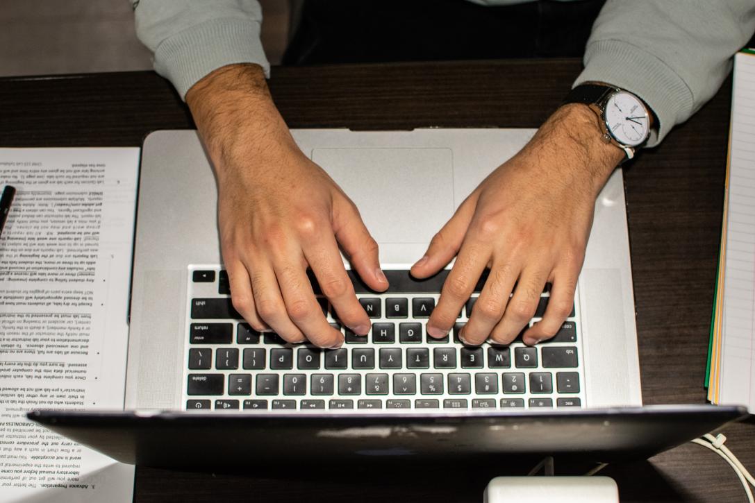 Person Typing Content on a Laptop