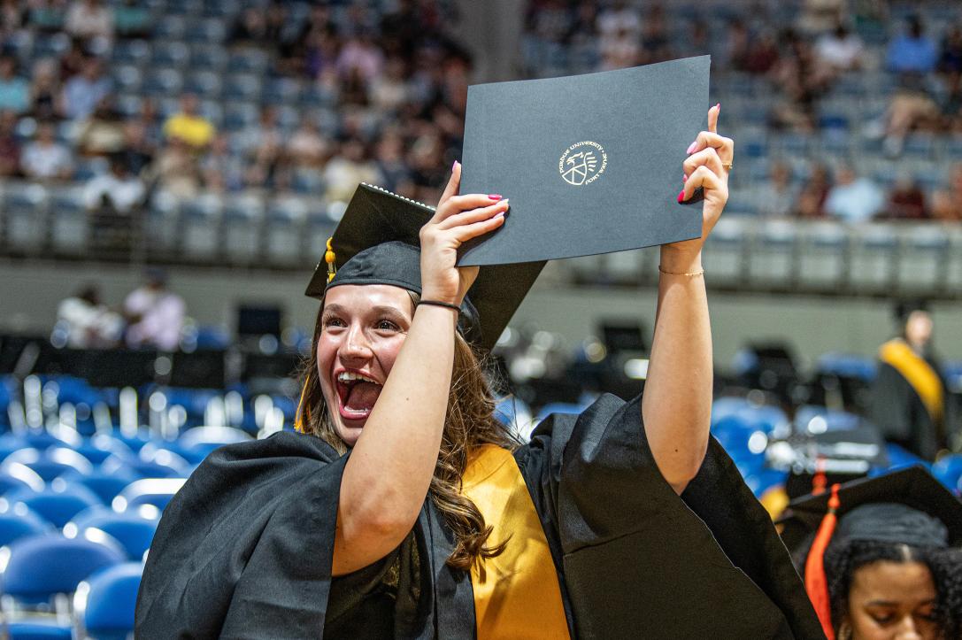 Student Celebrating Graduation with Her Degree