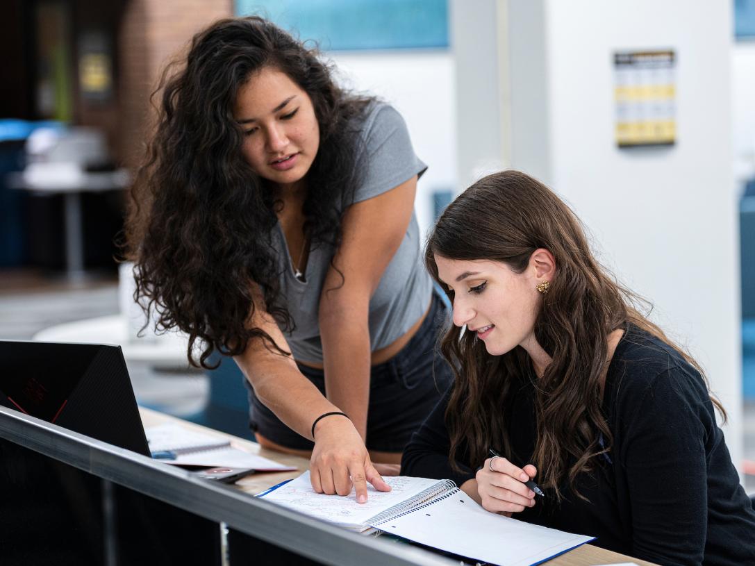 Two female students studying in the library