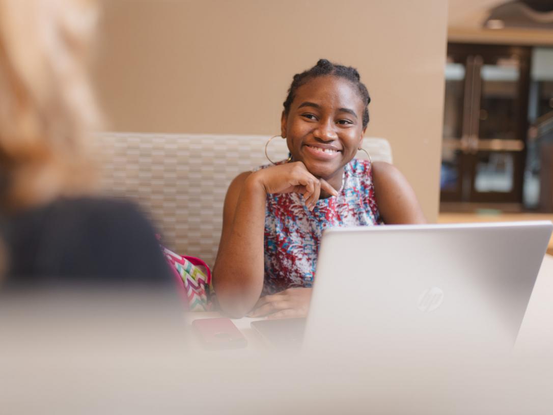 Female student discussing with an academic counselor.