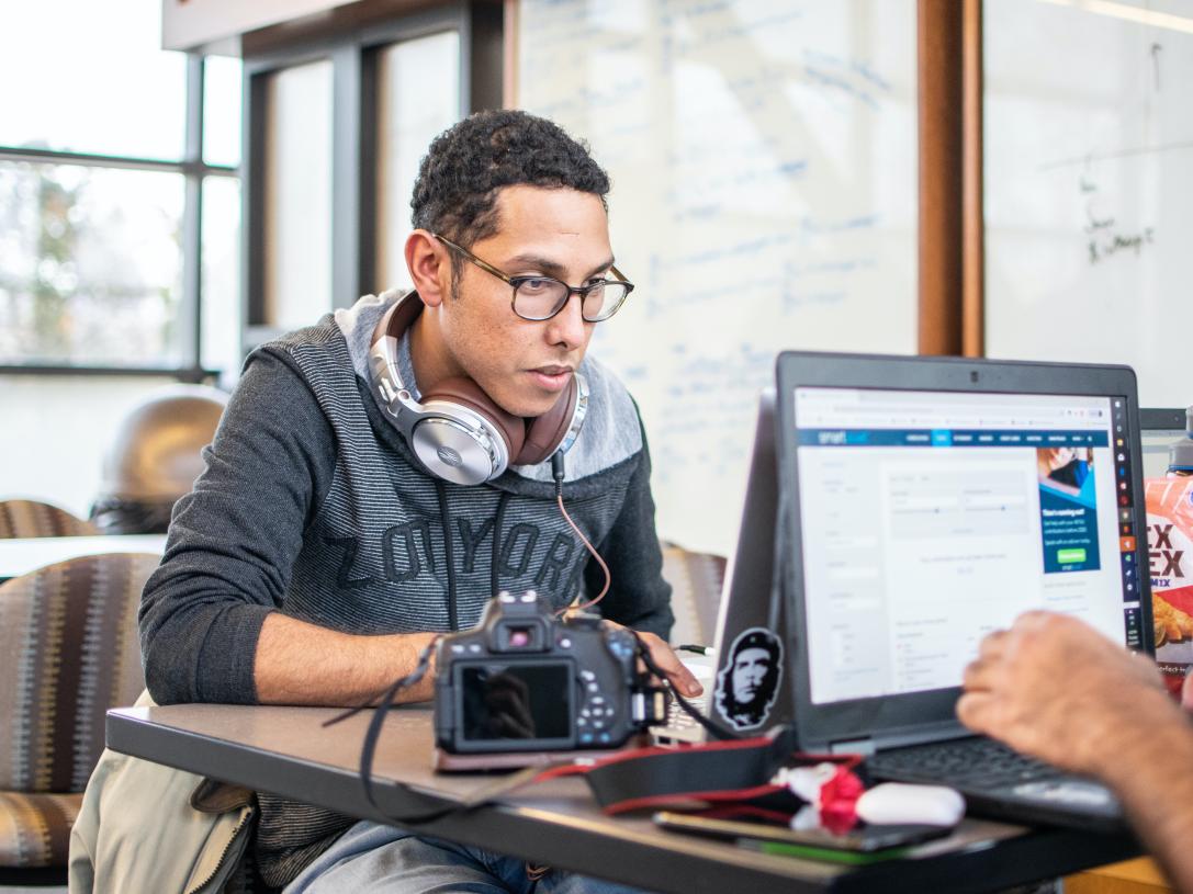 Student with headphones studying.