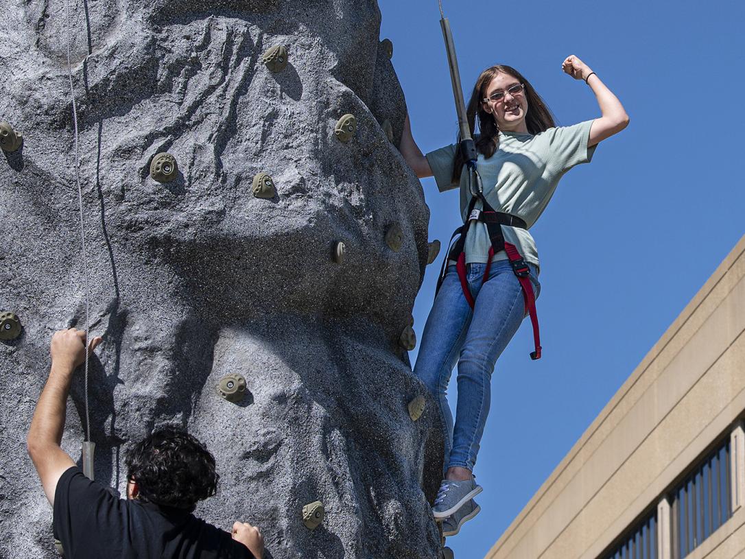 Students on a climbing wall during a fall event