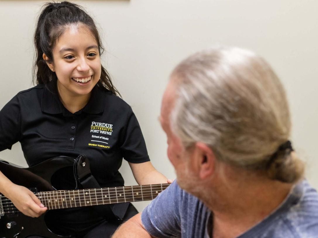 Emily Hernandez, a music therapy undergrad at Purdue Fort Wayne, uses her guitar to build relationships through shared music experience.