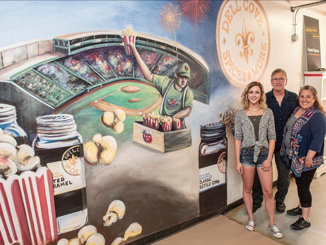 (Left to right) Sam Fulk, David, and Patricia Beets admire the mural.
