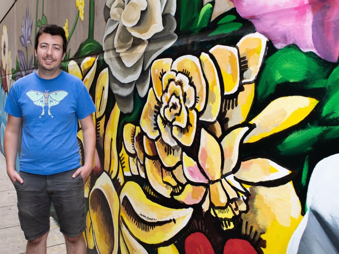 2014 PFW grad Jeremy Stroup (Sculpture) stands in front of the Hello mural he helped paint.