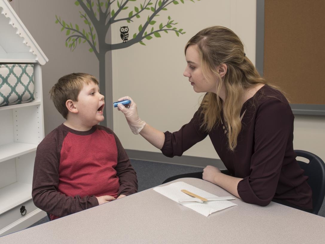 A CSD student works with a child