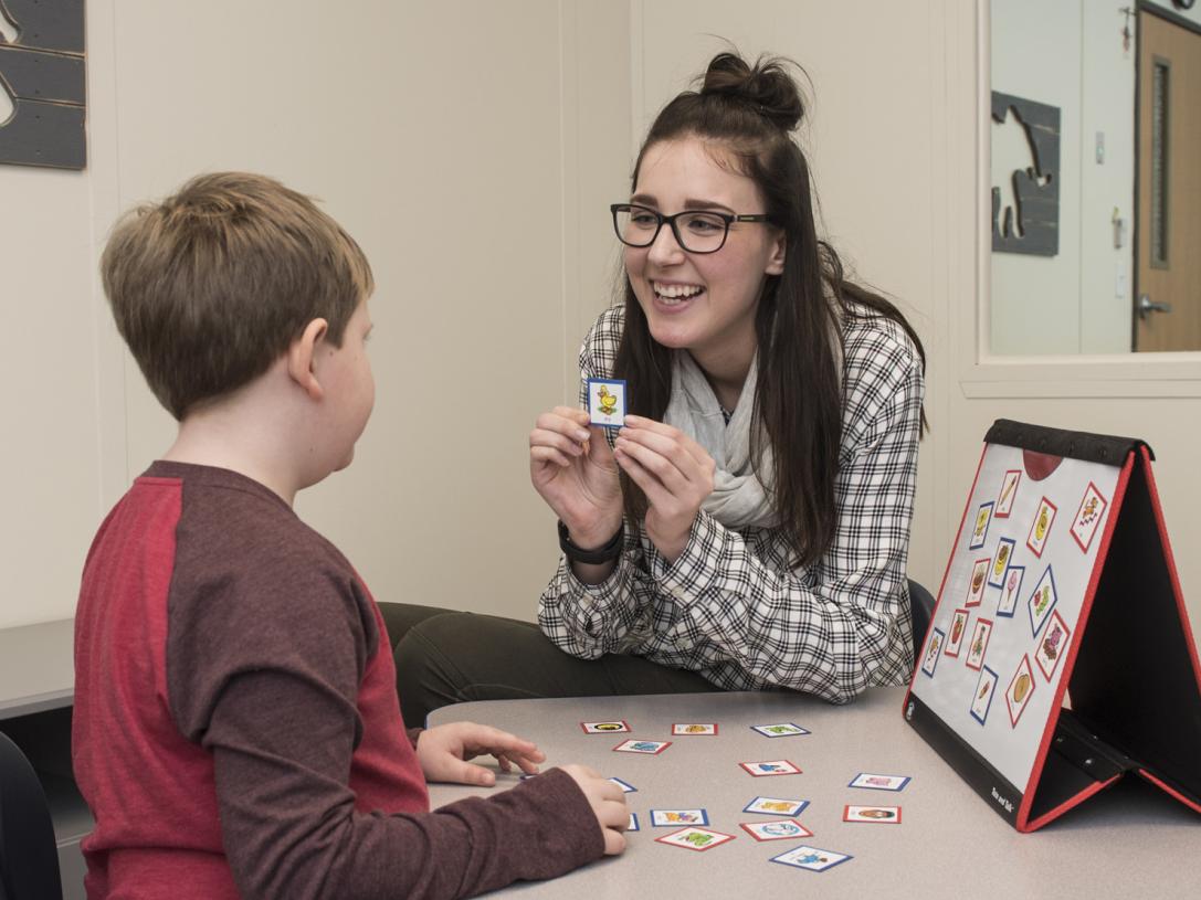 A CSD student works with a child