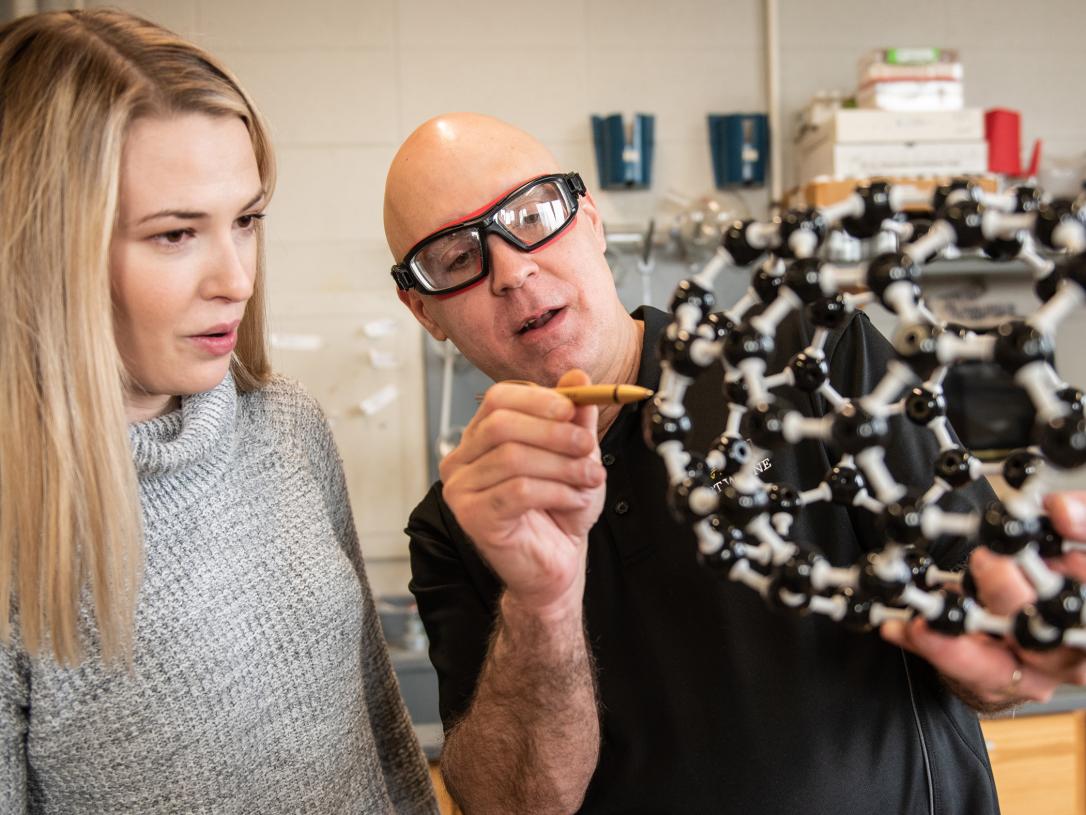 Professor Stevenson shows a model to a student
