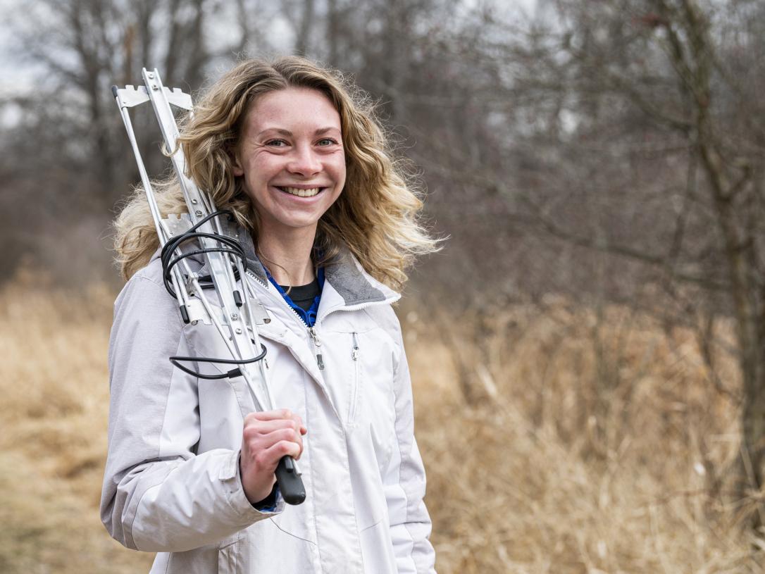 A female Biology student with radio gear at Eagle Marsh