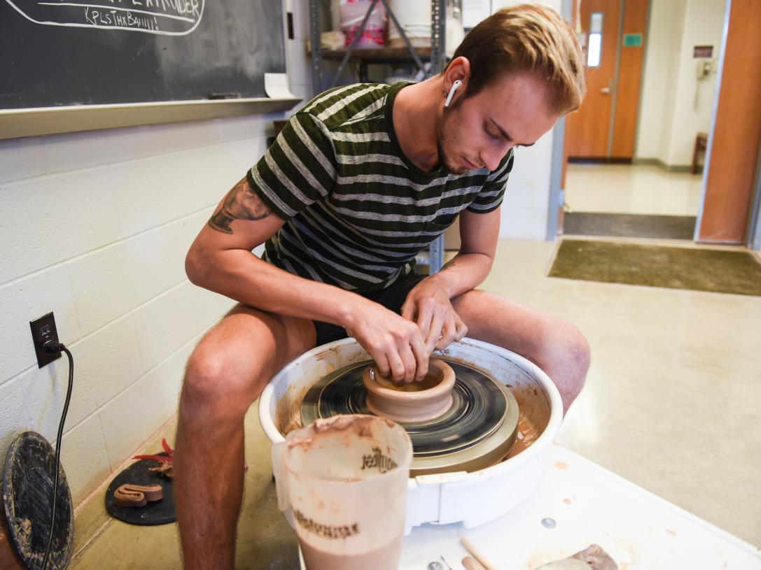 Student spinning a pot