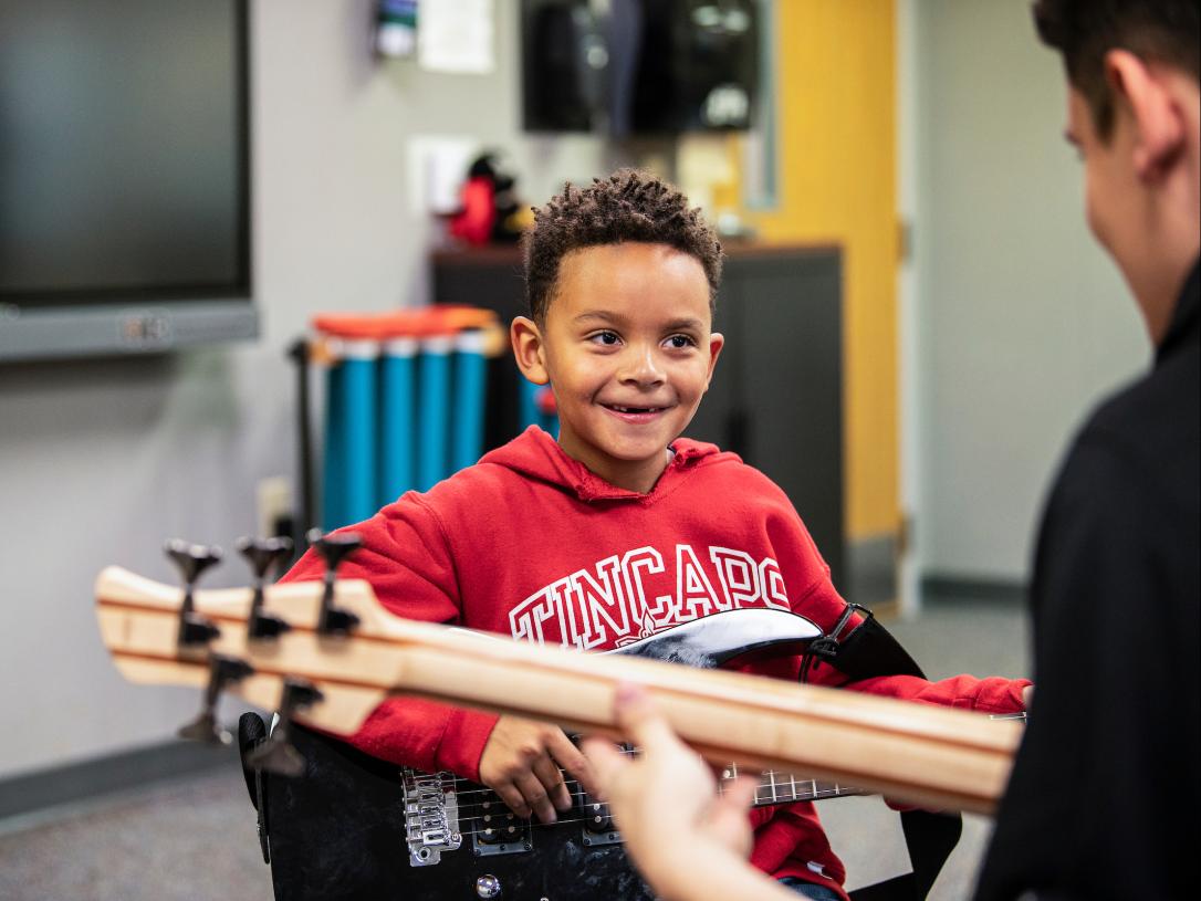 Child in music therapy inside Dolnick Hall.