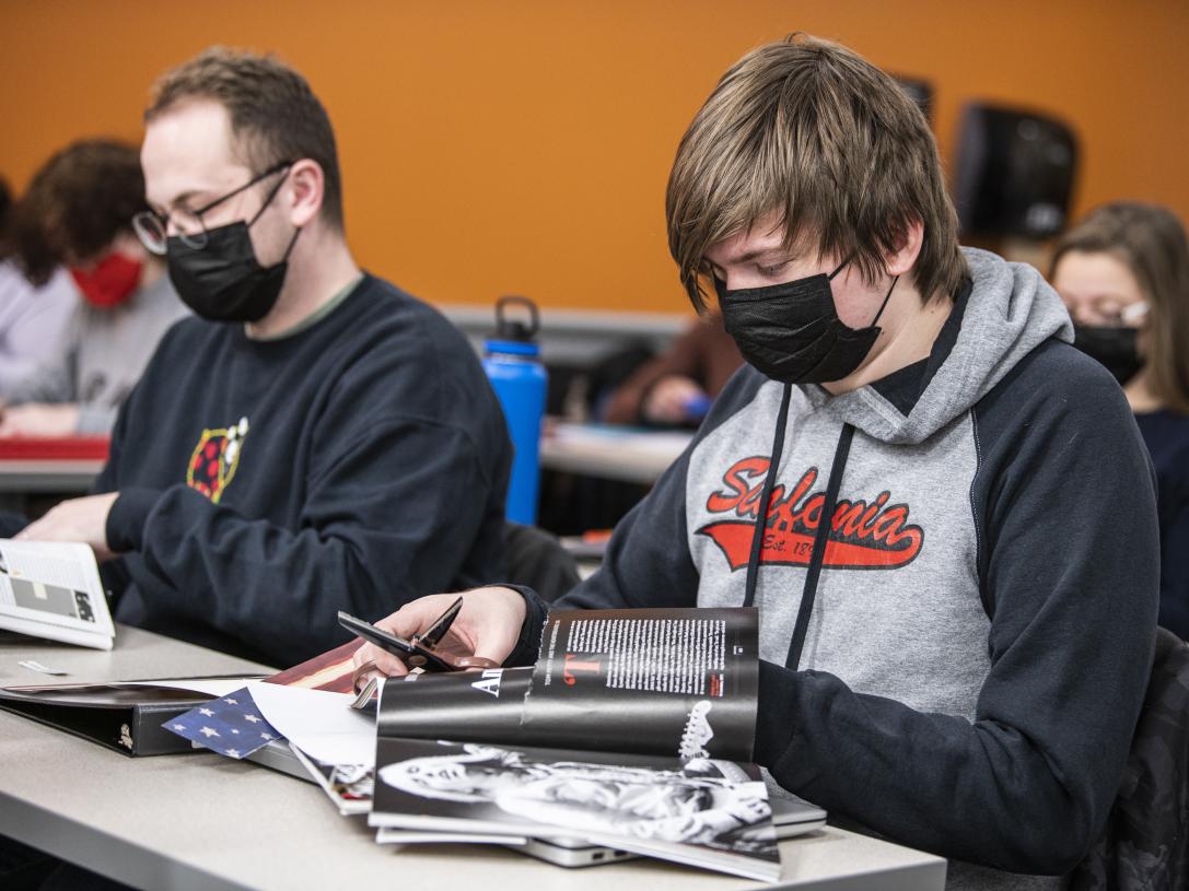Students working on collages in a Gender class