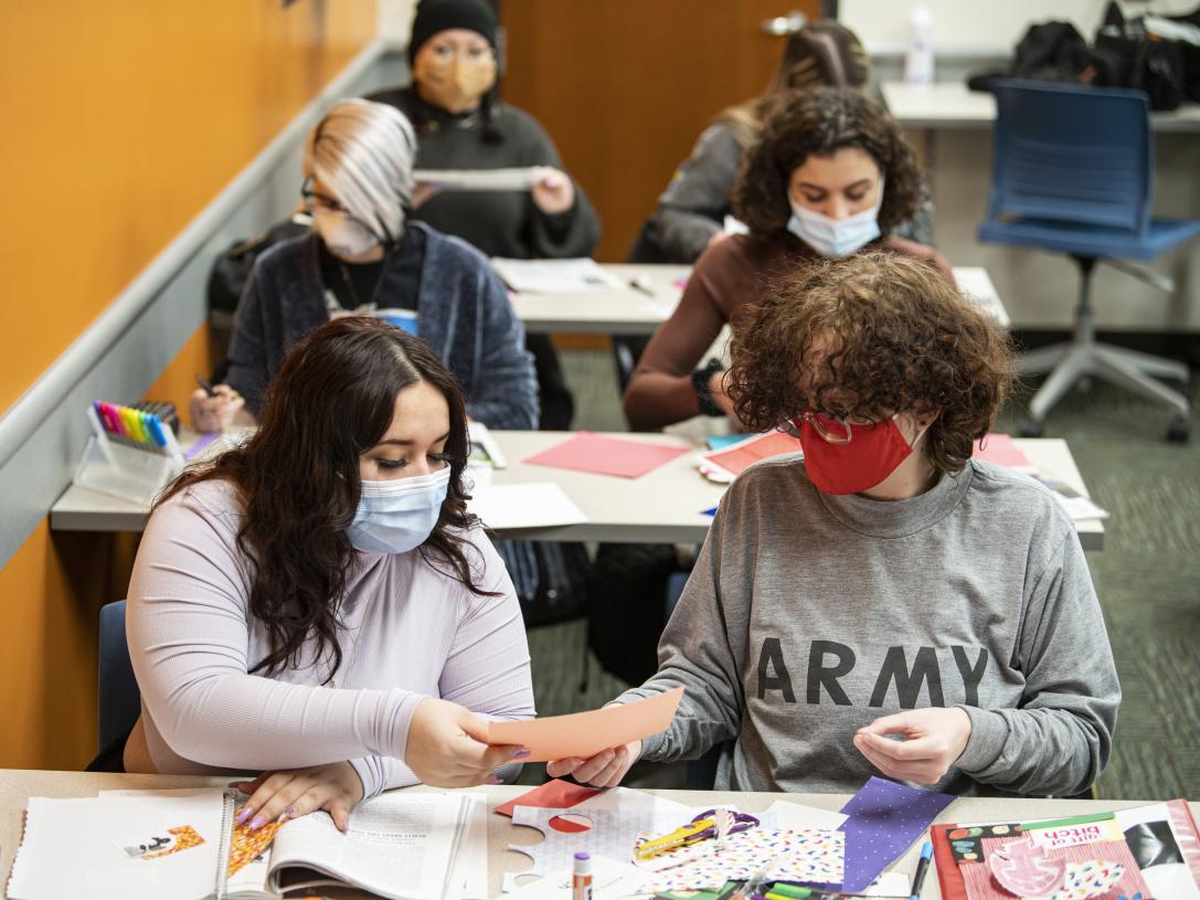Students working on collages in a Gender class