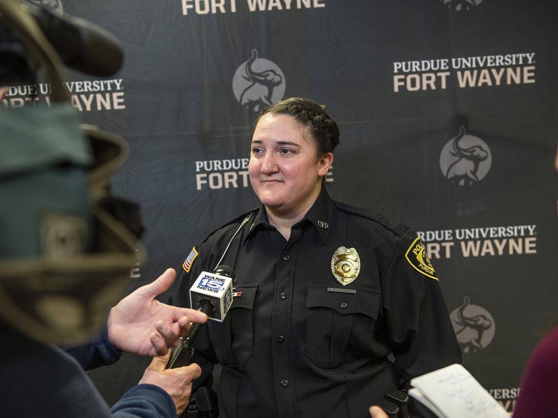 Officer Wojnarowski is being interviewed by members of the media
