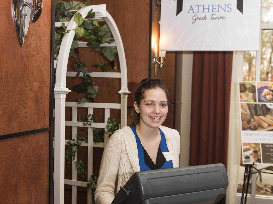 A student hosts the Athens Greek Tavern.