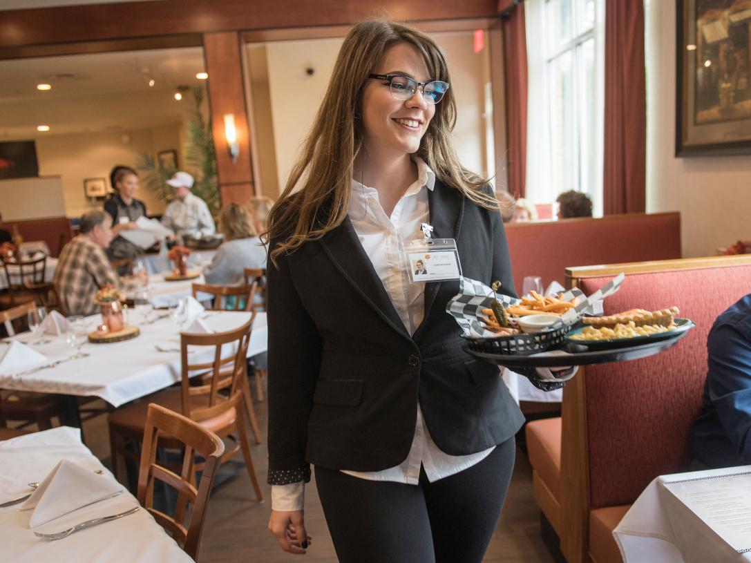 Hospitality student helps customers.