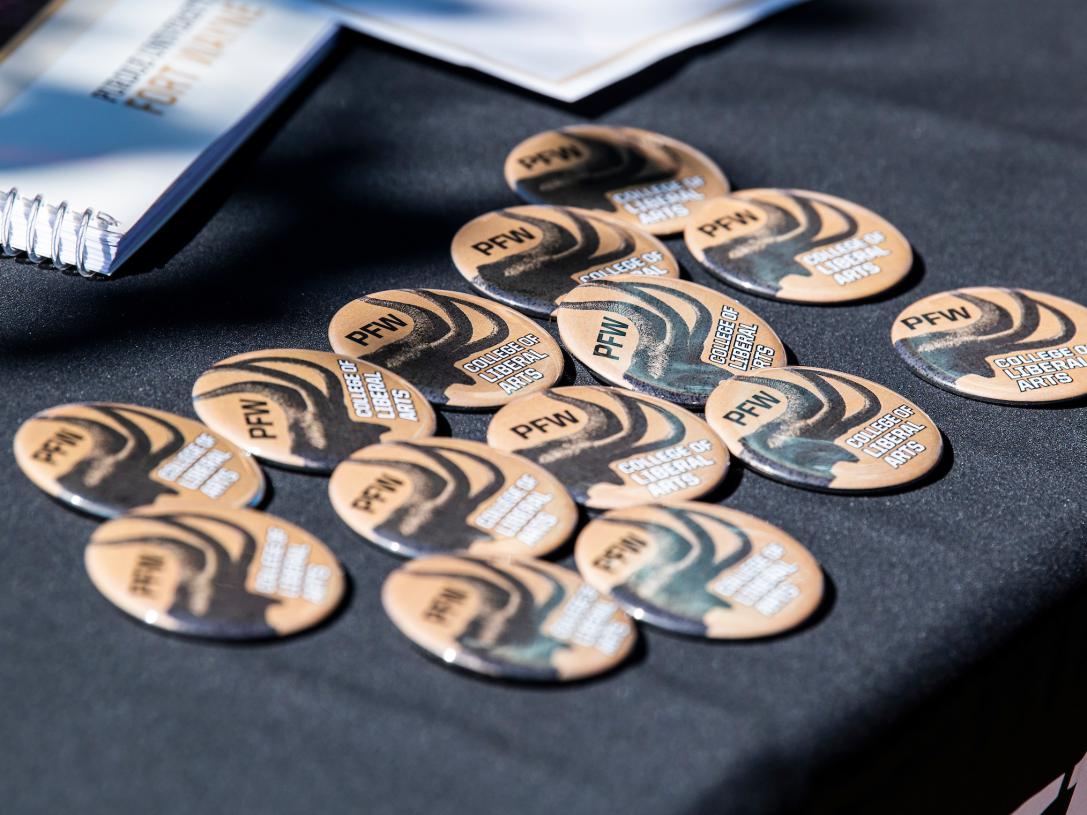 COLA pins on a table.