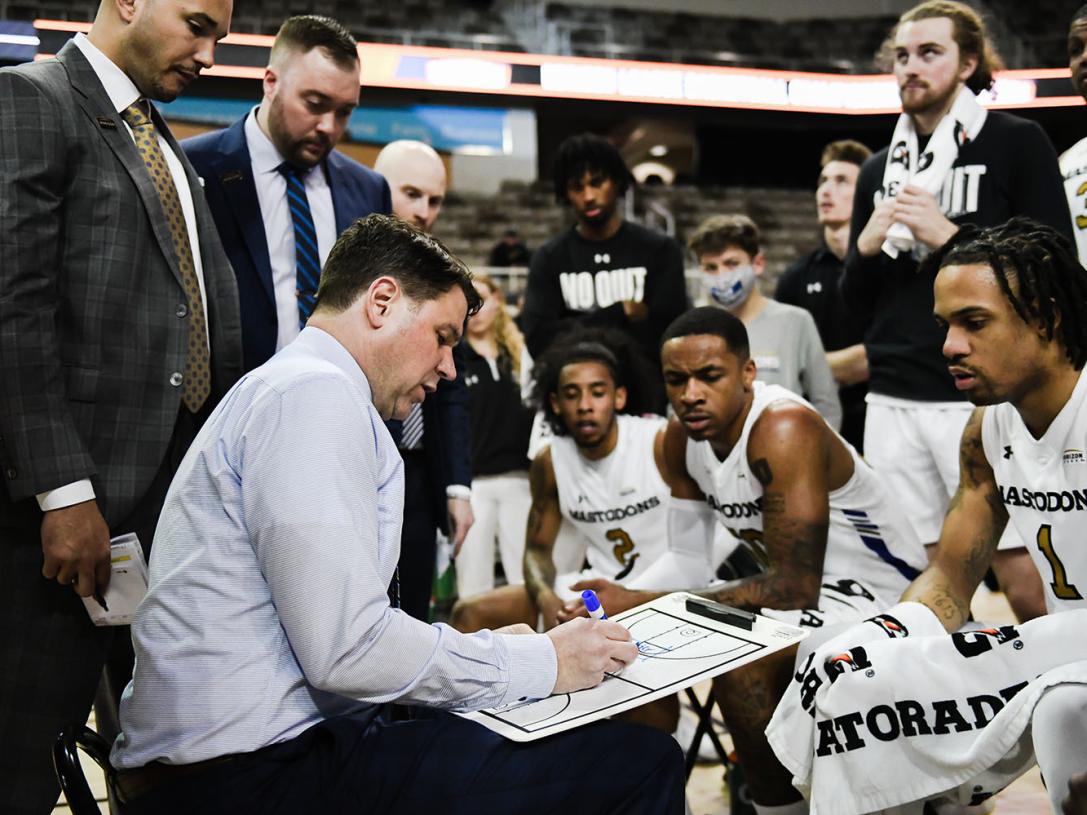 Coach Jon Coffman plans the next possession during a timeout.