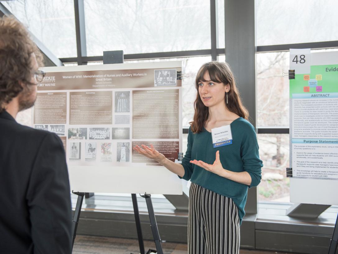 Student showing poster
