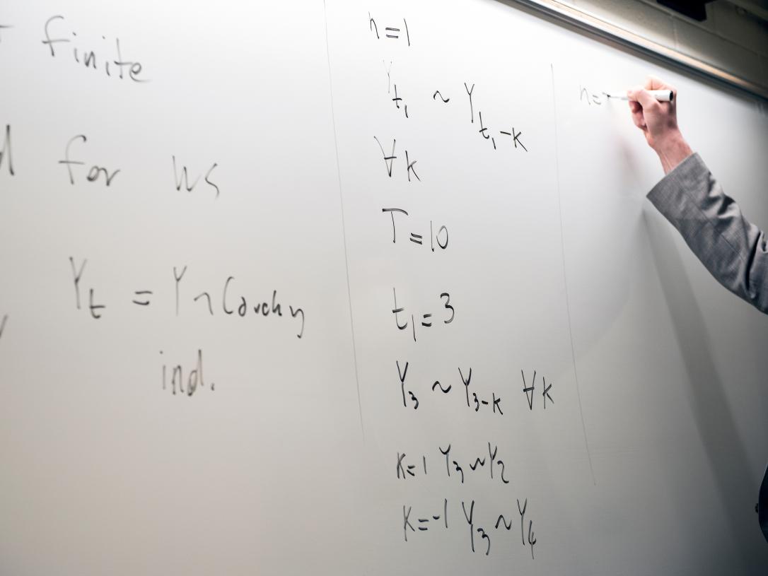 Whiteboard with math equations.