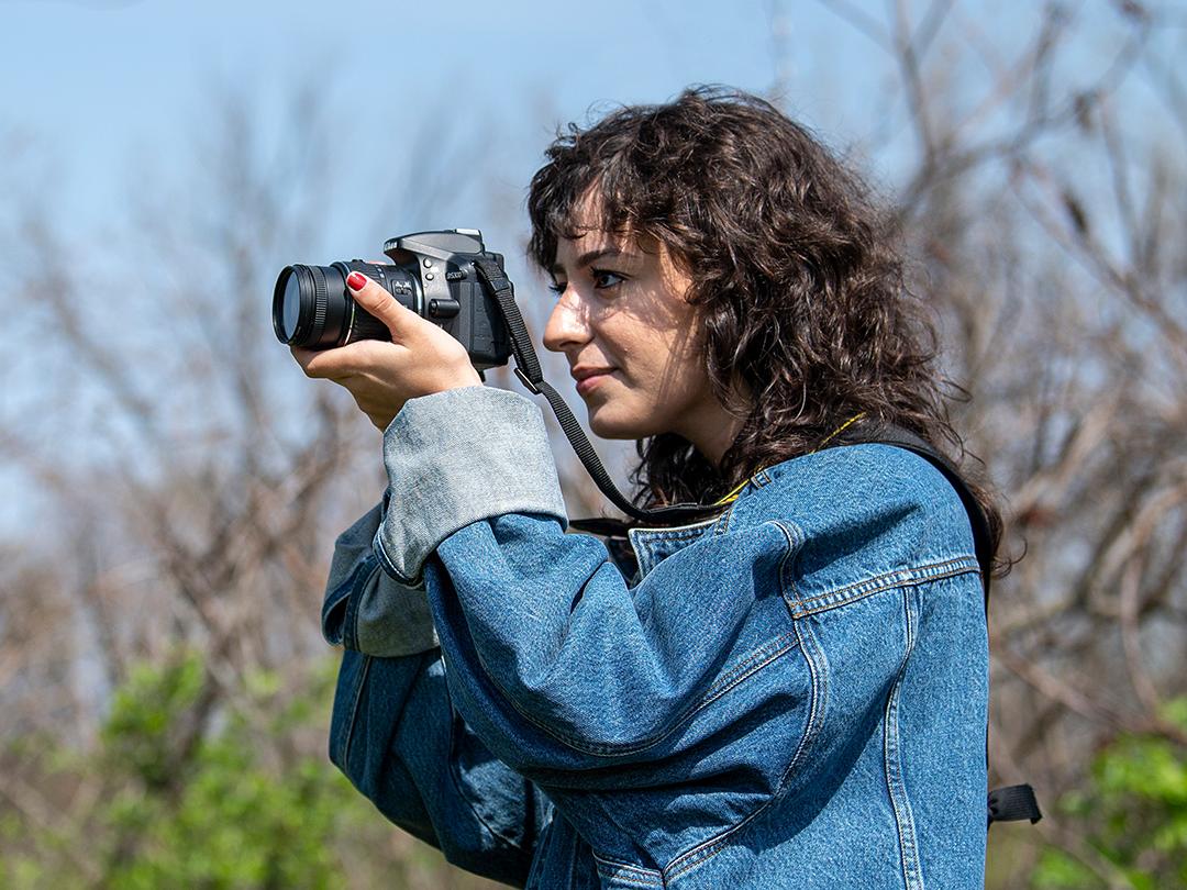 Portrait of Bella Ferrin taking pictures outside