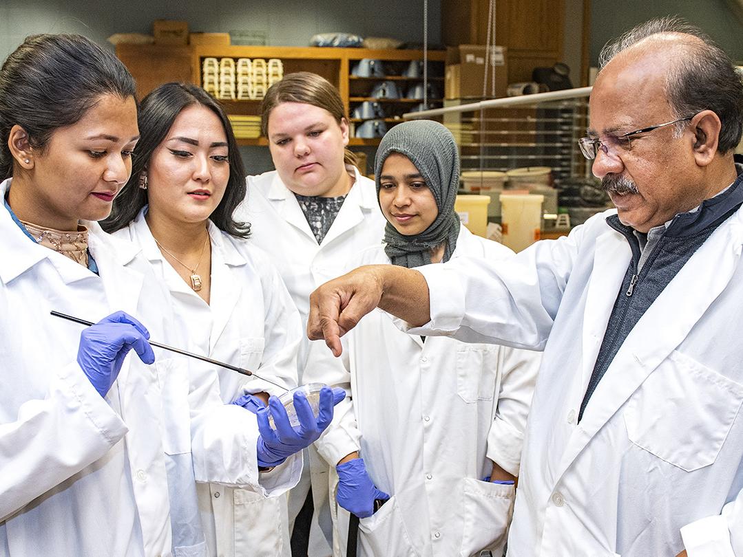 Ahmed Mustafa works with his lab assistants