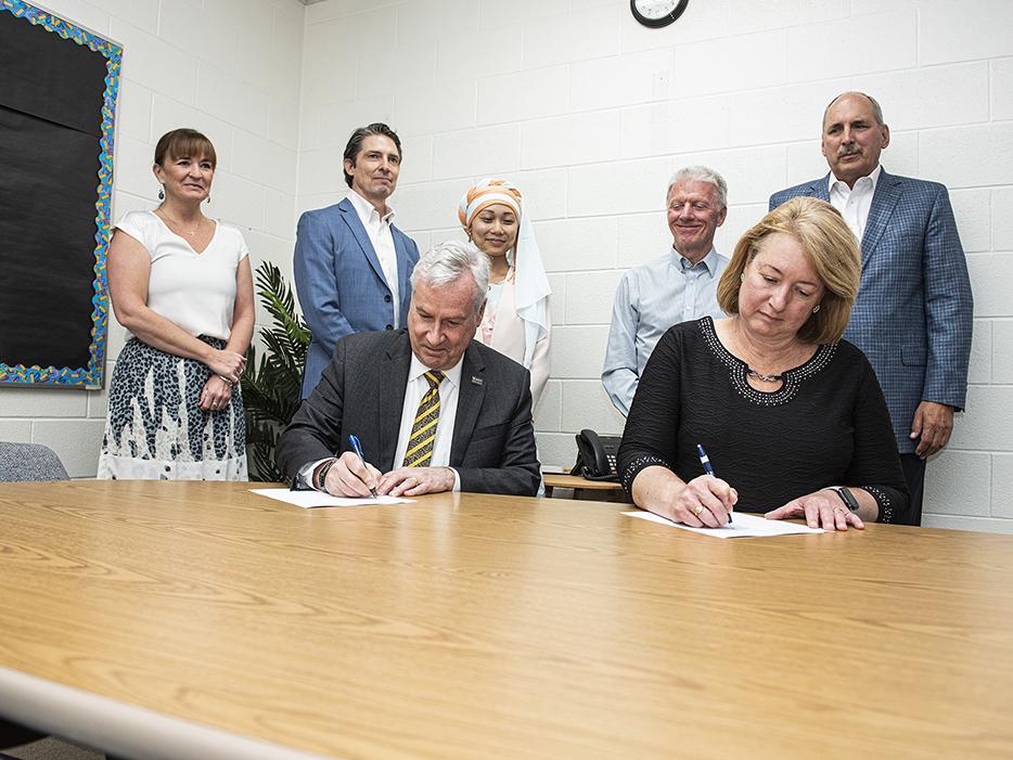 Chancellor Elsenbaumer and Superintendent Dawn Starks sign a memorandum of understanding.