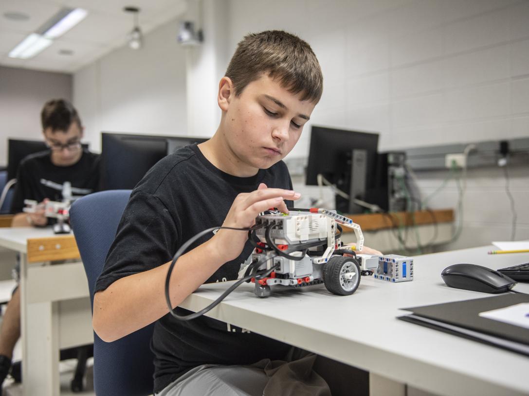 A student examines a robotics device