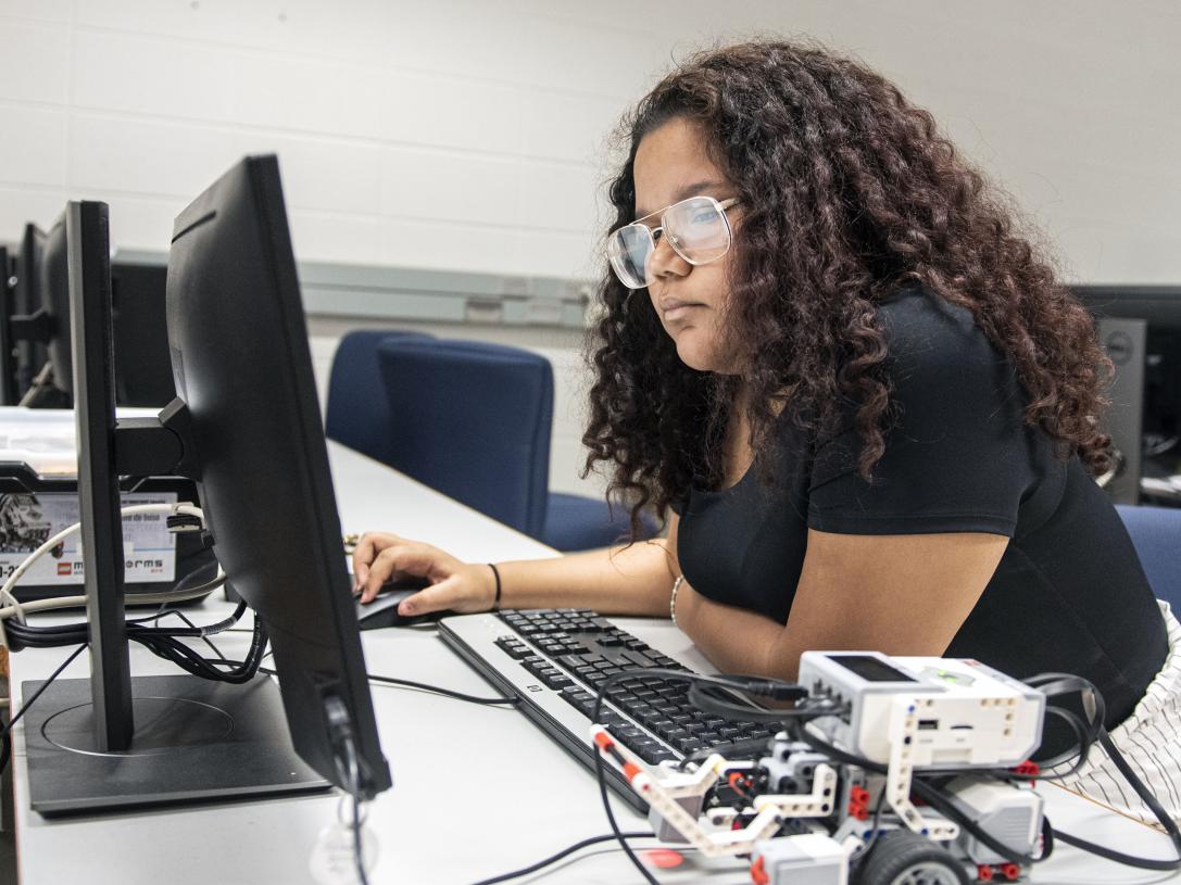 A student programs a robotics device