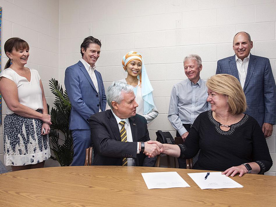 Representatives from Purdue Fort Wayne and Timothy J. Johnson Academy sign a memorandum of understanding.